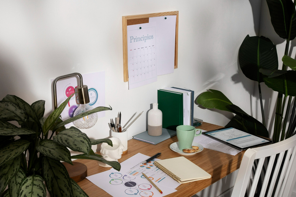 A tidy desk with a notebook and calm natural light